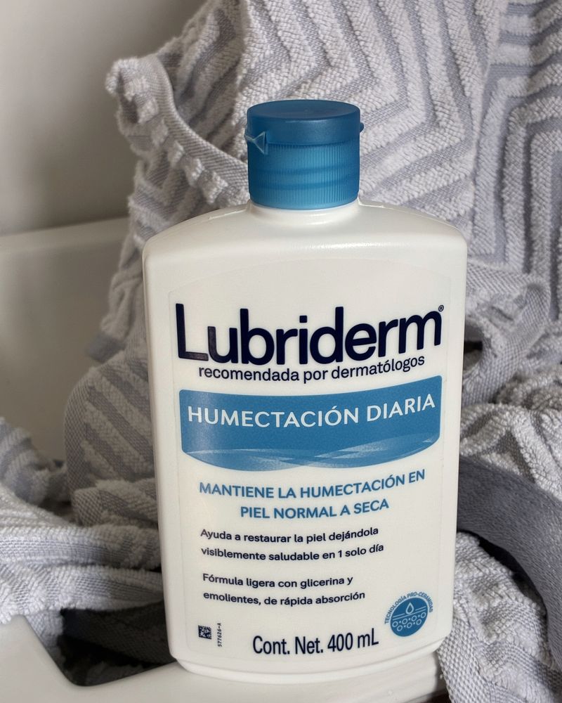 The Lubriderm bottle next to a towel in my bathroom